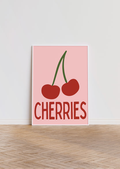 Poster with red cherries and 'CHERRIES' text on a pink background, leaning against a white wall.