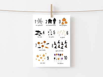 Halloween-themed numbered illustrations on a white card with a wooden clip on a white background