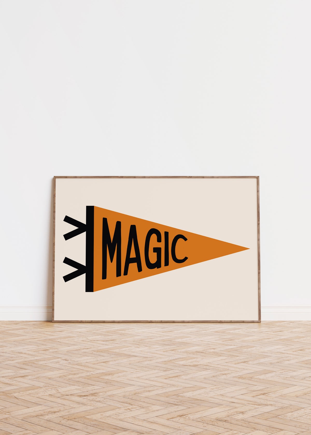 Whimsical ‘MAGIC’ pennant flag print in a frame against a white wall.